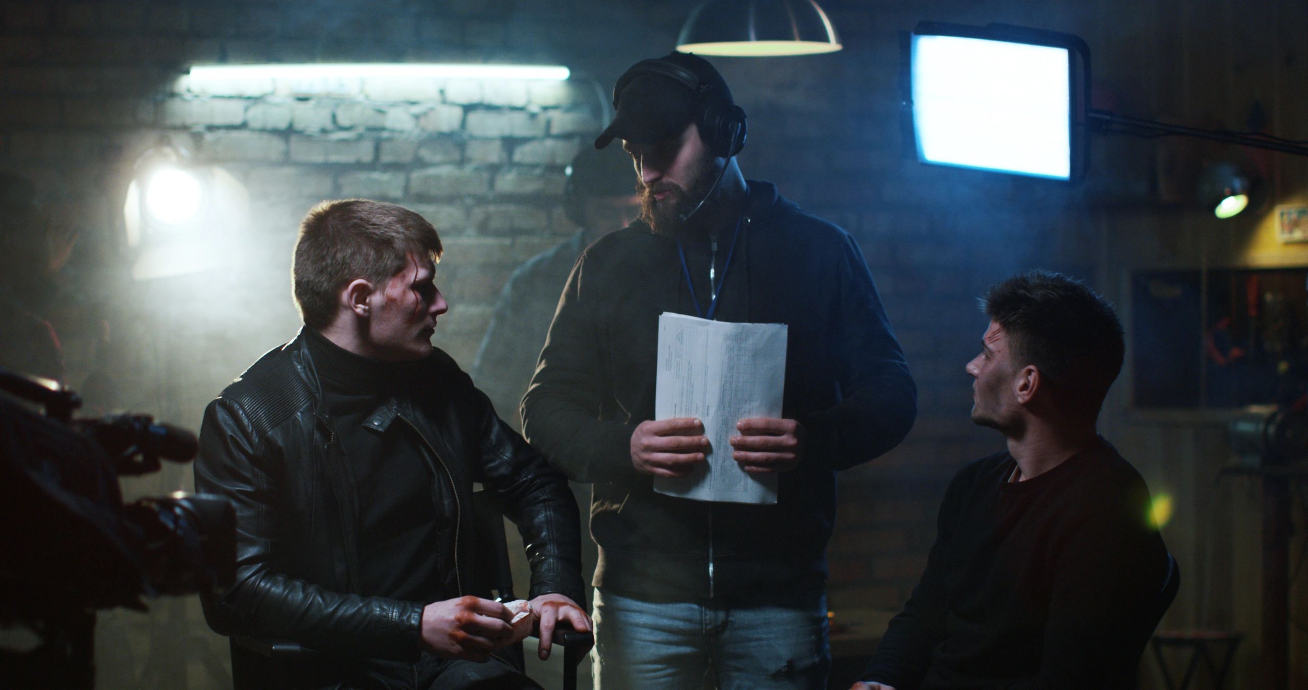 Director reviewing script and giving instructions on set